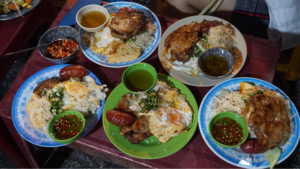 Enjoying a delicious plate of broken rice in Saigon will make you love this place more.
